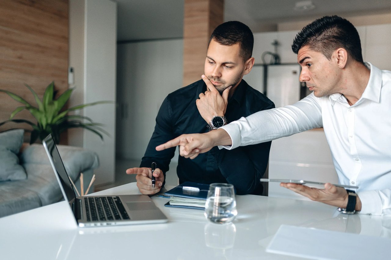 Newly promoted sales manager reviewing team performance metrics, KPI dashboards, and coaching plans to develop data-driven leadership and improve team results.