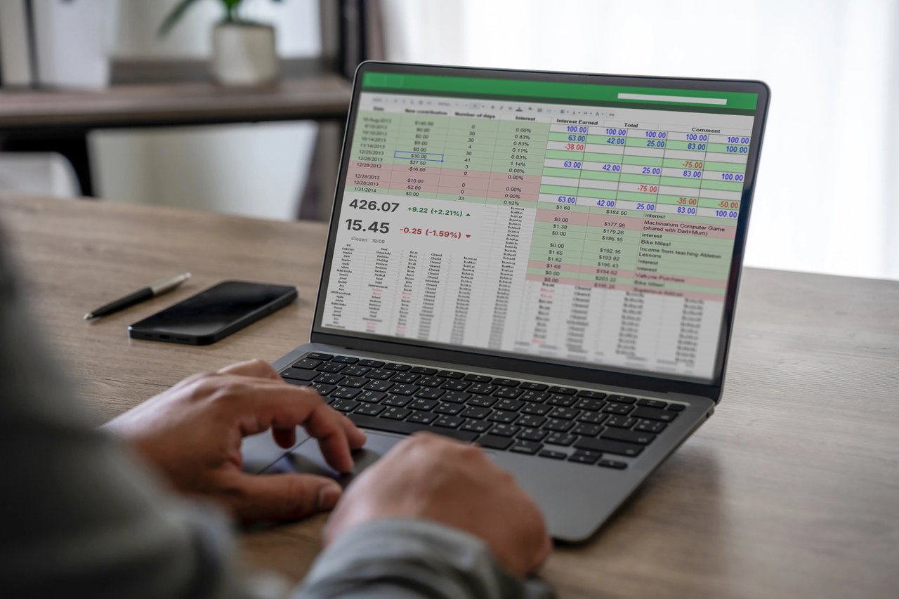 Business professional comparing an Excel spreadsheet with a modern analytics dashboard while evaluating reporting tools and data visibility.