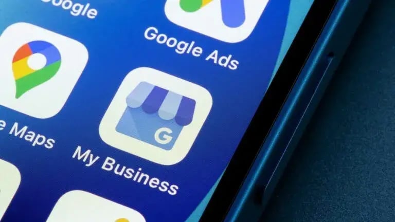 Business owner reviewing a Google Business Profile with customer ratings, reviews, photos, hours, and contact information.