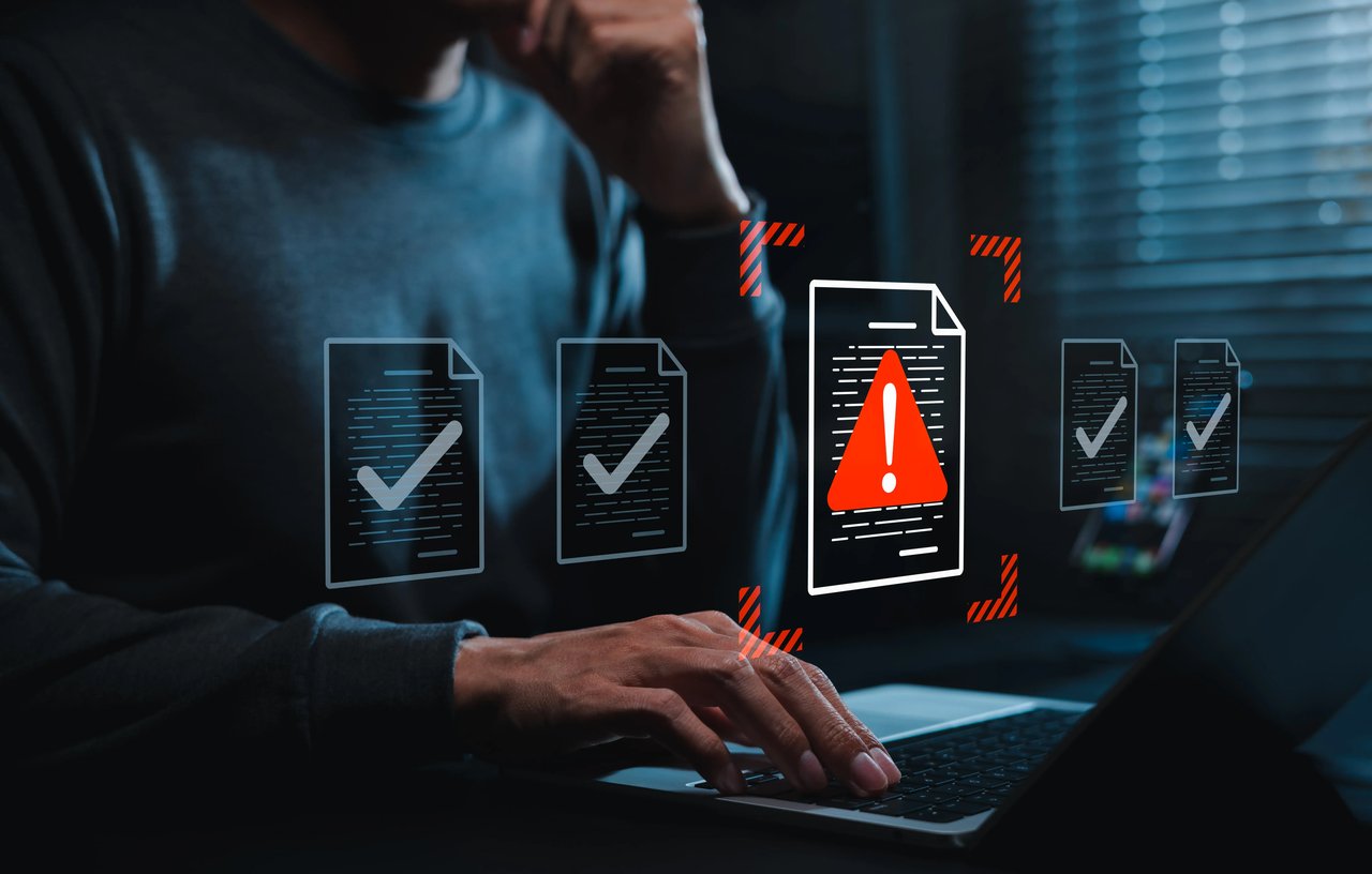 Business professional reviewing spreadsheets and analytics, illustrating the hidden costs of manual reporting, data errors, stale information, and lost productivity.