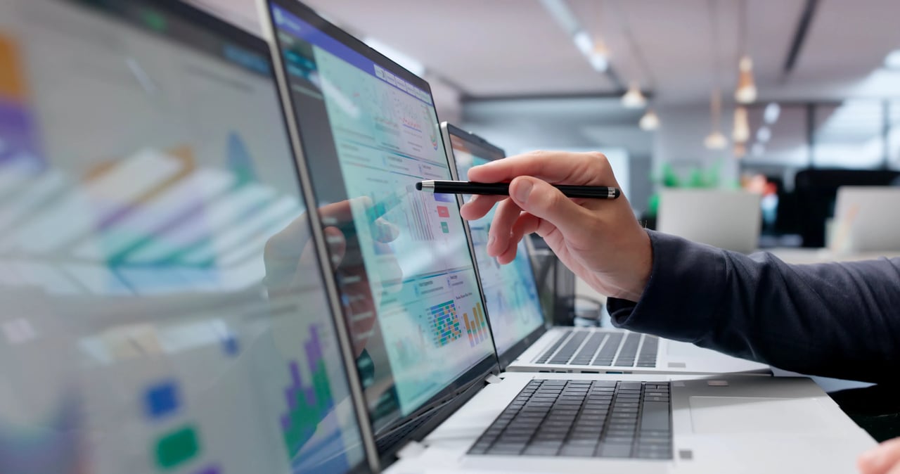 Sales team reviewing a real-time analytics dashboard with performance metrics, comparing reporting tools and data visualization options.