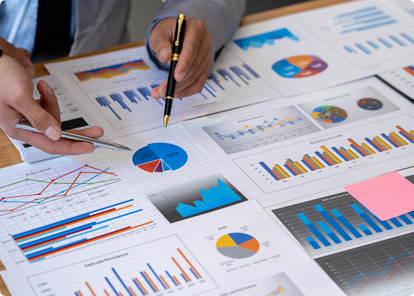 Hands trace with pen on graph printouts