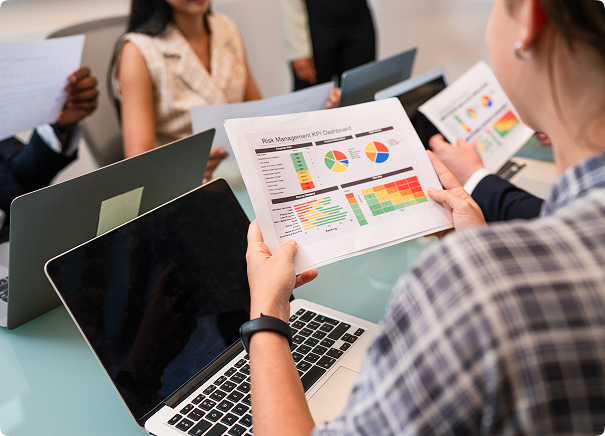 A man looks over dashboard printouts with graphs