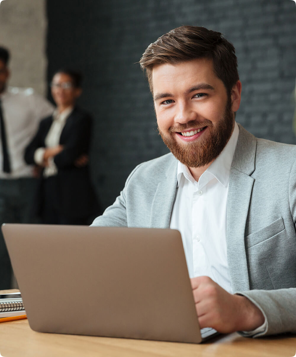 a man smiles confidently at the camera