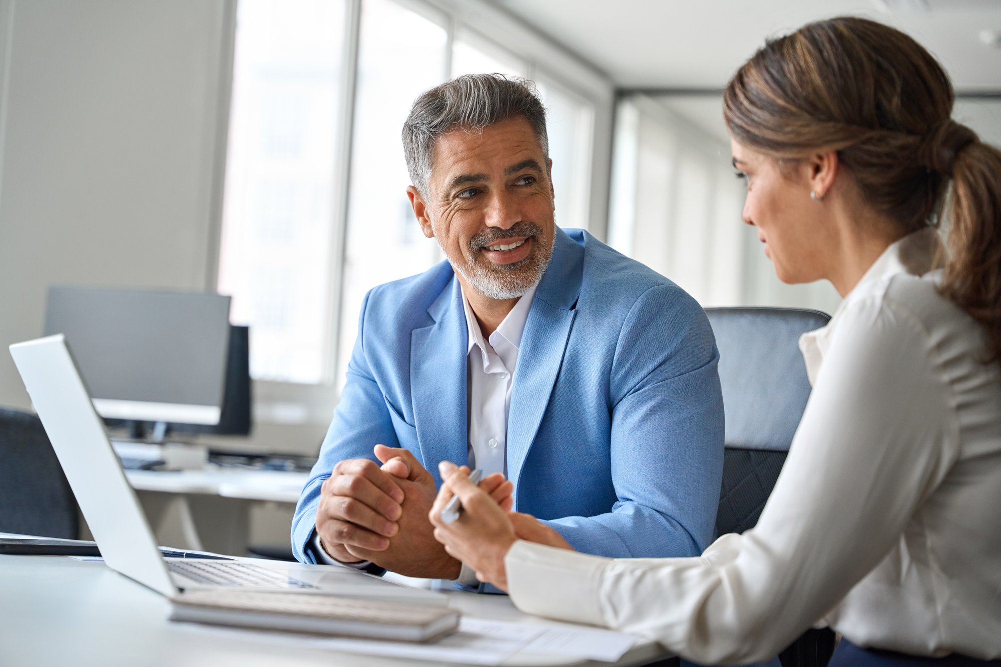 Insurance sales representative having a natural conversation with a prospective customer, using an engaging question to build rapport and keep the cold call moving.